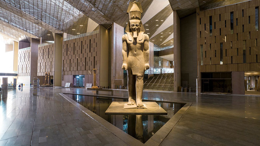 visitors viewing king tutankhamun treasures at grand egyptian museum